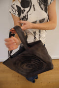 vintage rosette leather handbag